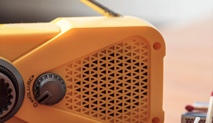 Close-up view of a yellow radio with volume dial