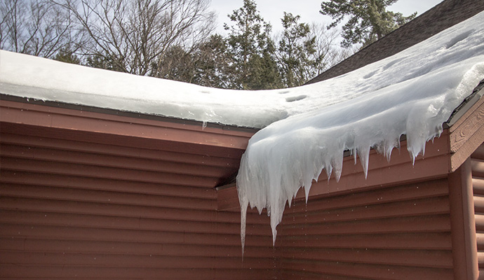Heavy snow and ice damaged roof gutter