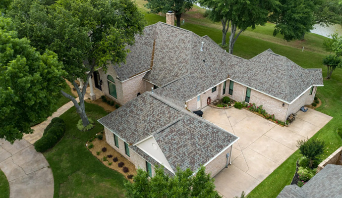 Suburban house with a newly installed asphalt shingle roof